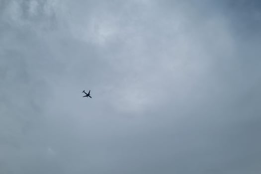 Airplane Silhouette Against Cloudy Sky - Tranquility and Wanderlust for Travel Themes photo