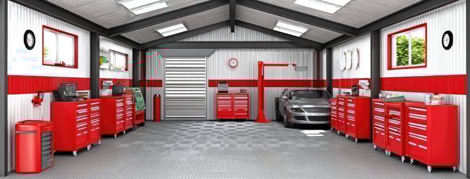 A garage with red and white cabinets and a car photo