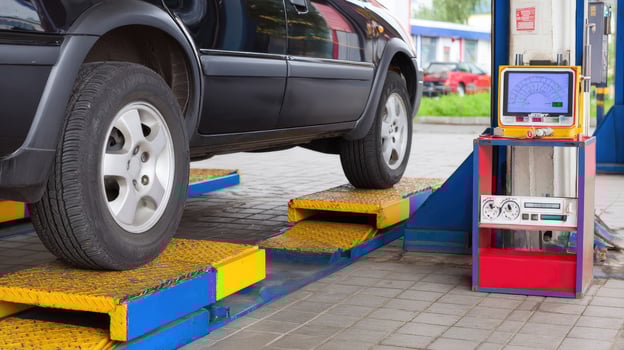 A car is being checked on a lift photo
