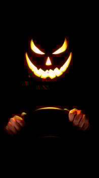 Halloween pumpkin face on the steering wheel photo