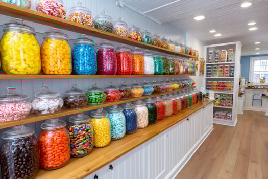 Colorful candy displaying on shelves in candy store. ... photo