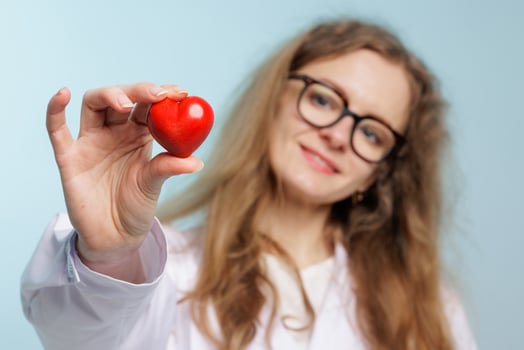 Female Doctor Holding Red Heart Symbol Promoting Cardiovascular Health and Medical Care photo