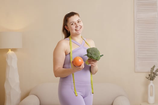 Happy Plus Size Woman Holding Broccoli and Grapefruit Diet Healthy Eating and Weight Loss Concept photo