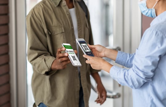 Covid-19 Control. Female Worker Scanning Health Qr Code Of Black Male Visitor On Entrance To Public Place, Unrecognizable African Man Demonstrating Digital Vaccination Certificate On Smartphone photo
