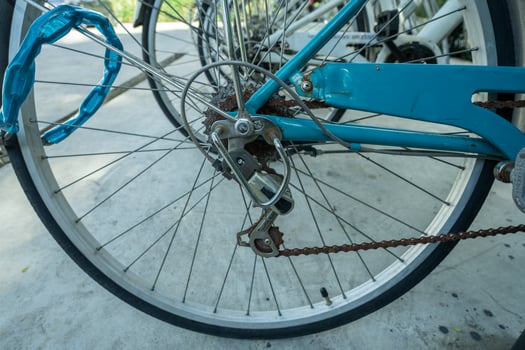 Close-up of bicycle wheel parked in bike rack at eco-friendly hotel. Sustainable transportation options for environmentally conscious guests during leisure travel. Sustainable mobility solution. photo