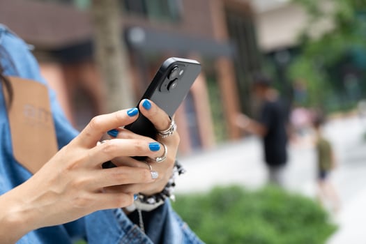 Woman Using Smartphone with Blank Screen Technology Concept. woman's hands holding and interacting with a smartphone that has a blank black screen. modern technology, communication. photo