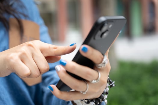 Close up of female hands using modern smartphone device outdoors. modern activity of staying connected and engaged through mobile technology. photo