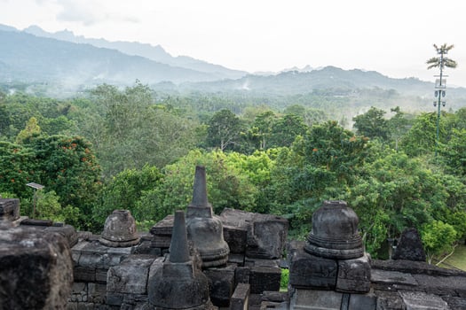 Tranquil Landscape View from Ancient Stone Structure towards Green Forest Mountain photo