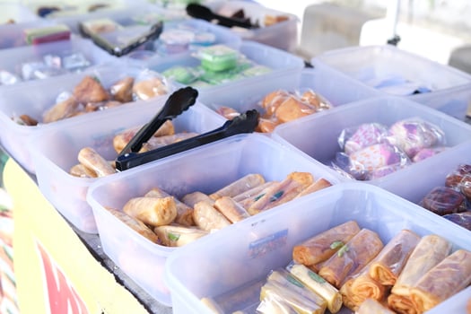 Street Food Vendor Selling Spring Rolls and Other Asian Delicacies photo