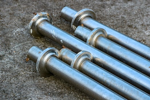 Arrangement of Metal Pipes on Concrete Surface Industrial Material photo