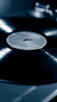 Close Up of a Vinyl Record Spinning on a Turntable. A Detailed Image of the Record's Surface and the Turntable's Mechanism. photo
