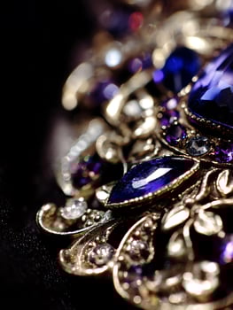 Close Up of an Ornate Jewel with Deep Blue and Purple Gemstones. photo