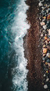 Ocean Wave Meeting Colorful Pebbles on a Shore. A close up view of the meeting point of sea water and a beach. photo
