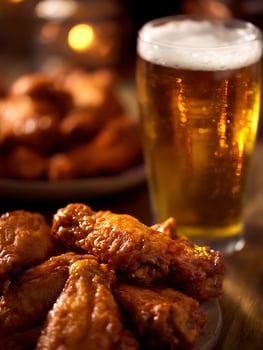 Close up of Delicious BBQ Chicken Wings with a Glass of Beer. photo