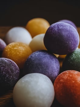 Close up of colorful, textured spheres arranged on a wooden surface. photo