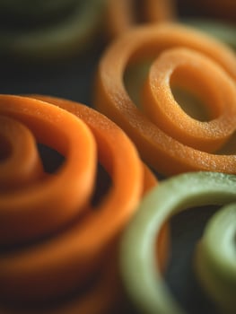 Close Up of Spiral Sliced Carrots and Zucchini. A vibrant food photography image perfect for culinary themes. photo