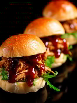 Delicious Pulled Pork Sliders with BBQ Sauce and Arugula. A close up shot of three gourmet mini burgers, perfect for food blogs, restaurant menus, or culinary websites. photo