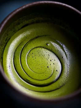 Close up of Swirling Matcha Green Tea in a Bowl. photo