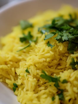 Close up of Cilantro Garnish on Yellow Rice. A Detailed Food Photograph. photo