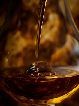 Amber Liquid Pouring into a Glass, Close Up. A Detailed Image of a Golden Beverage Filling a Glass. photo