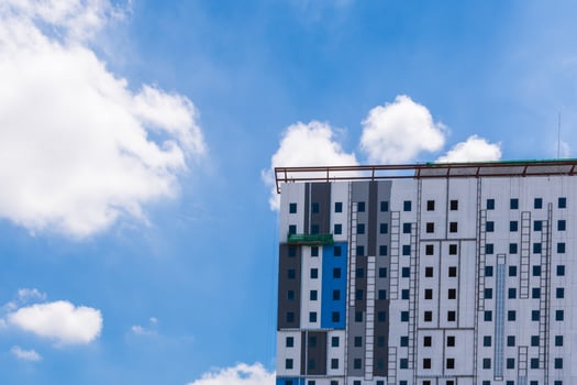 A building with a blue sky and clouds photo