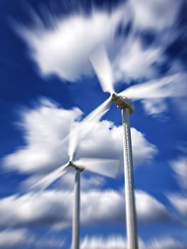 Dynamic Wind Turbines Against a Blurred Sky. A captivating image showcasing the power and movement of renewable energy. photo