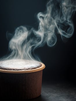 Steaming Hot Chocolate Lava Cake in Dark Brown Ramekin. photo