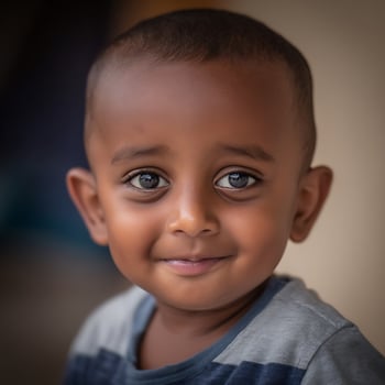Portrait of a Young Boy with a Sweet Smile. His expressive eyes and gentle expression create a heartwarming image. photo
