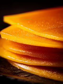 Close Up of Stacked Slices of Candied Citrus Fruit, Glistening Texture. photo