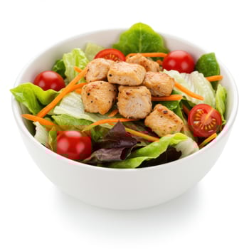 Fresh chicken salad with tomatoes and carrots in a white bowl photo