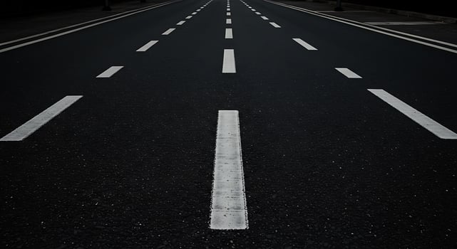 An empty road with white lines on it photo
