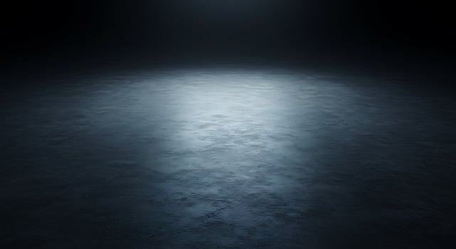An empty room with a light shining on it photo