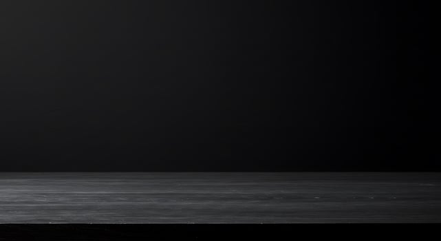 Black table top with empty glass bottle on top photo