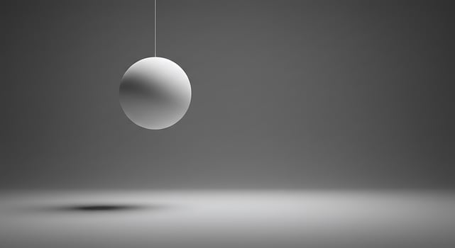 A white egg hanging from a wire in a dark room photo
