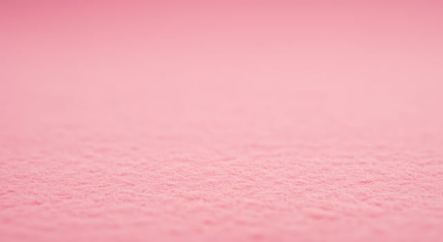 A pink background with a small amount of snow photo