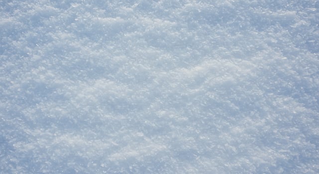 A snow covered ground with a skier on top photo