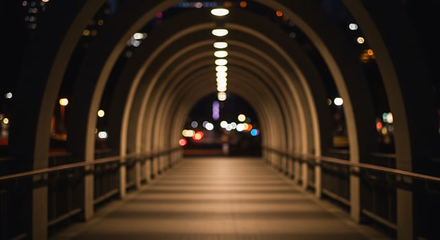 A blurry photo of a bridge at night