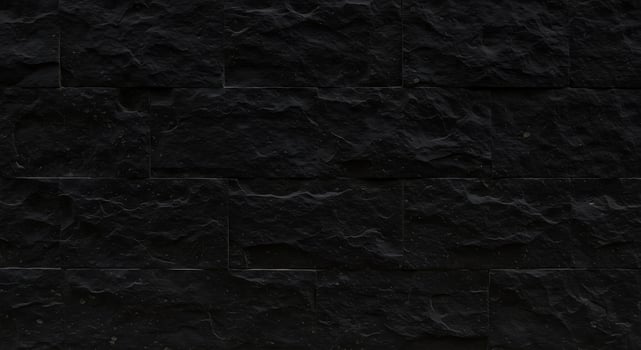 A black stone wall with many different shapes photo
