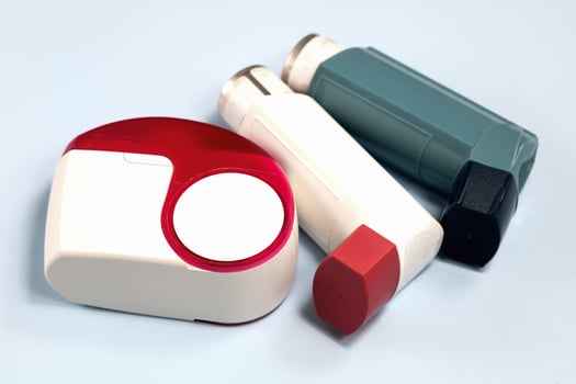 Various asthma medications inhalers on table photo