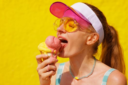 Young Woman Enjoying Melting Ice Cream Cone on a Hot Summer Day Outdoors photo