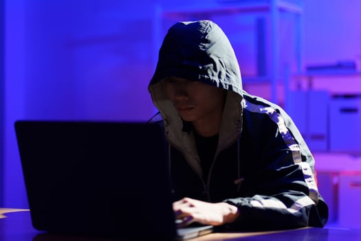 Hacker executing cyberattack to breach data and compromise digital security photo
