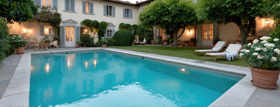 A pool in a courtyard with a patio and lawn chairs photo