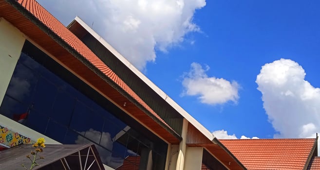A building with a blue sky and clouds in the background photo