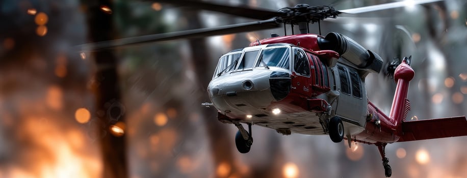 A helicopter flying over a forest fire photo
