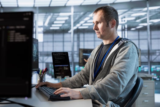 Computer scientist implementing cybersecurity measures to protect data center assets and information. Server hub IT expert monitoring and analyzing metrics to enhance operational effectiveness photo