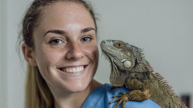 Vet Assistant Smiling With Exotic Iguana on Shoulder in a Light, Inviting Clinic Environment photo