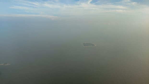 A serene sky view featuring soft clouds taken from a plane in flight. photo