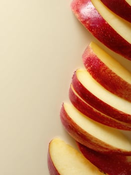 Sliced Apples Arranged Vertically With a Smooth Background Providing a Clean Aesthetic Suitable for Presentations or Culinary Displays photo