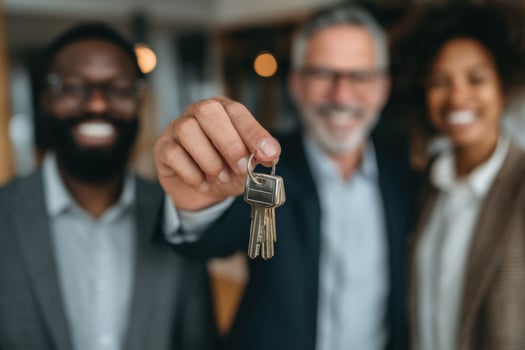 A group of people holding keys and smiling photo