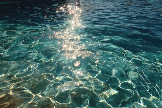 Sunlight shining through the water on a beach photo